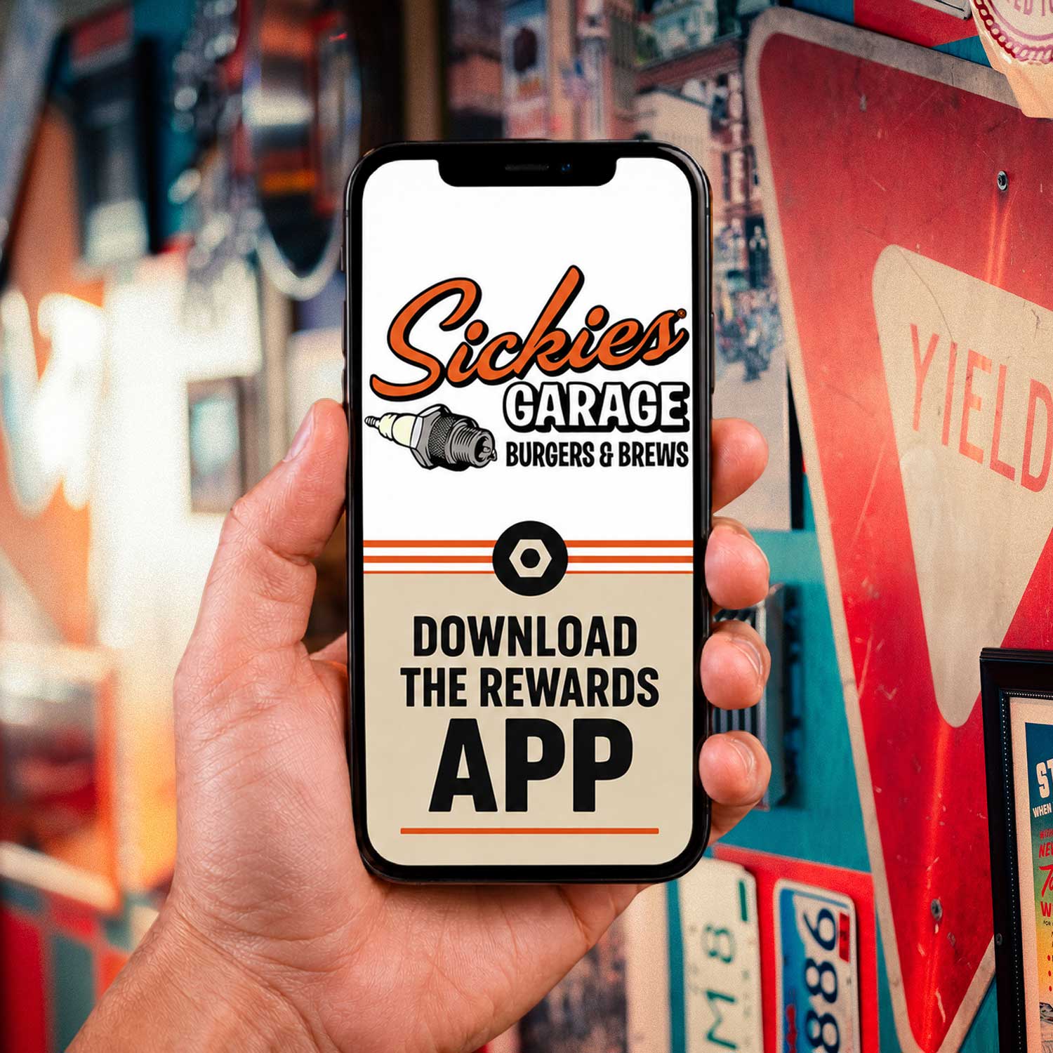 A hand holding a cellphone showing the Sickies Rewards App