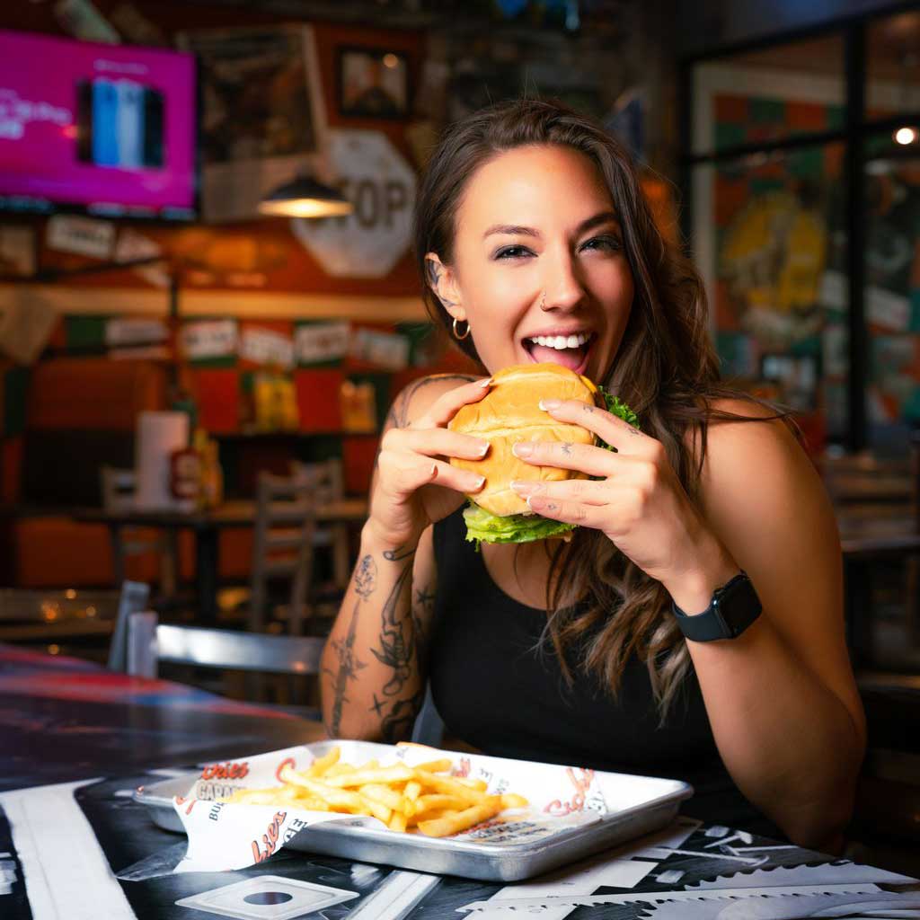 Happy customer eating a burger